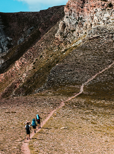 Group hiking on a mountain trail at Minds and Mountains business retreat