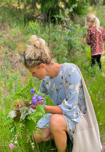 Doro harvesting herbs during outdoor activity at Regenerative Living Retreat